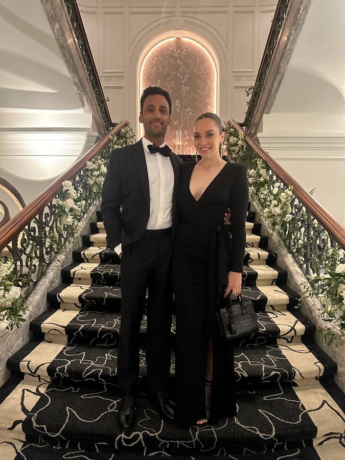 Jen and Rob in black tie on a grand staircase